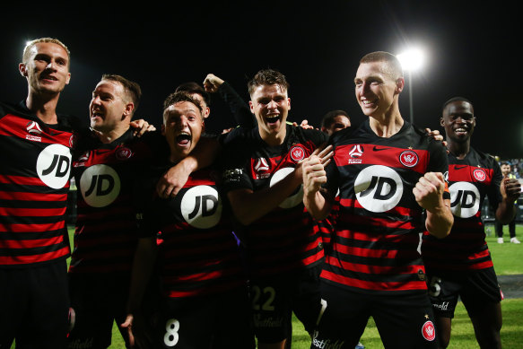 Wanderers celebrate their derby win over Sydney FC on Friday night.