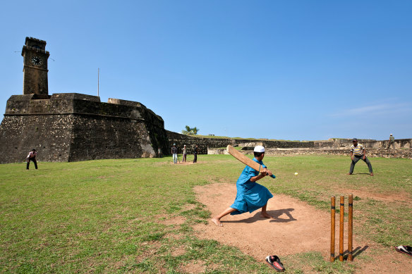 Boys playing cricket near Galle Fort, Sri Lanka.