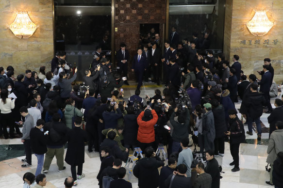 South Korean lawmakers gather at the Natio<em></em>nal Assembly after Yoon’s surprise announcement.
