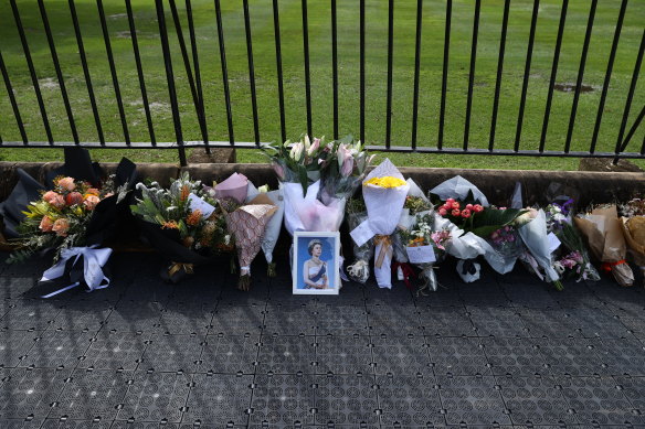 A framed photo of Queen Elizabeth among floral tributes outside Government House in Sydney on Friday.