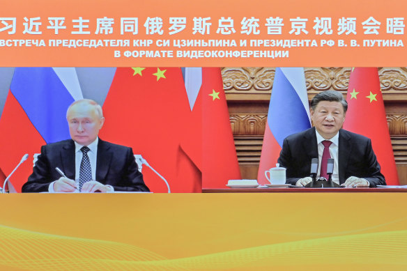 Chinese President Xi Jinping and Russian President Vladimir Putin (left) appear on screen during a meeting via video link. CCTV news gives greater credence to Russia but also provides a perspective from Ukraine.