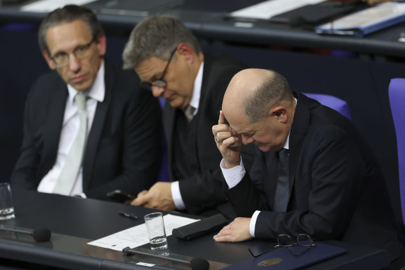 German Chancellor Olaf Scholz (right), Economy and Climate Action Minister Robert Habeck and German Finance Minister Joerg Kukies (left) attend debates before Scholz lost a vote of confidence at the Bundestag.
