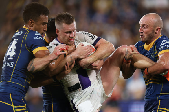 Cameron Munster is wrapped up by the Eels’ defence.