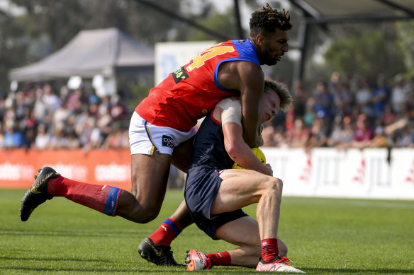 Archie Smith (left) lays a tackle.