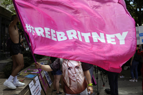 A Britney Spears supporter waves a “Free Britney” flag outside a court hearing concerning the pop singer’s conservatorship.