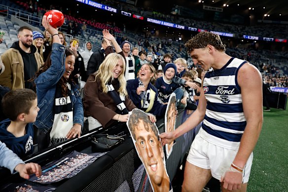 Jay Polkinghorne of the Cats celebrates with friends and family post game.