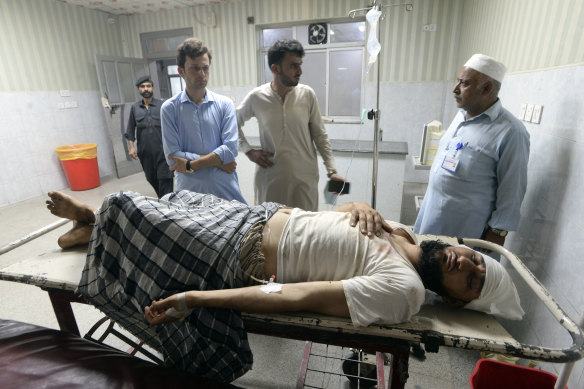 An injured victim lies on a bed at a hospital in Peshawar, Pakistan.