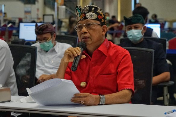 Bali Governor Wayan Koster announces the re-opening of the island to foreign tourists at an empty Ngurah Rai International Airport.