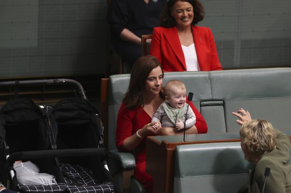 Federal Labor MP Anika Wells arrives with babies Ossian and Dashiell (in pram) during a division.