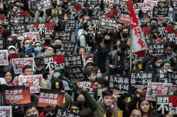 Tens of thousands of people march through the streets of the Causeway Bay district of Hong Kong on January 1.