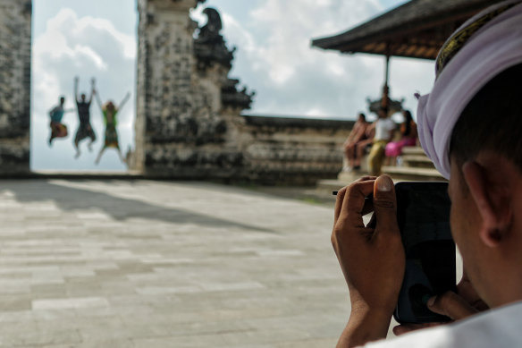 Tourists pose at Lempuyang Temple, also known as the Gates of Heaven.