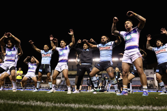 Warriors and Sharks players perform a haka for retiring star Shaun Johnson.