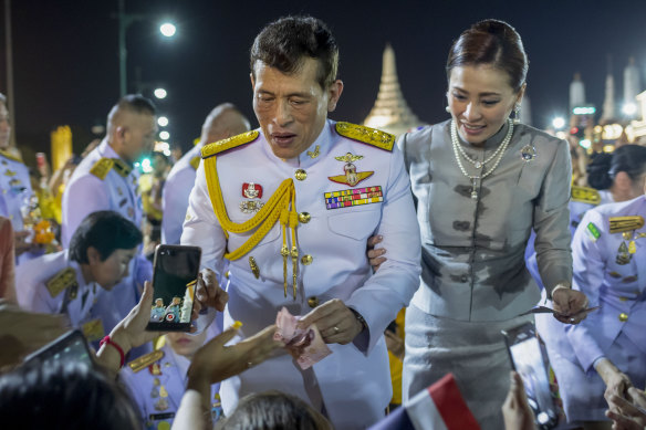 Thailand’s King Maha Vajiralongkorn, son of the late King Bhumibol, greets supporters with with Queen Suthida in Bangkok in 2020.