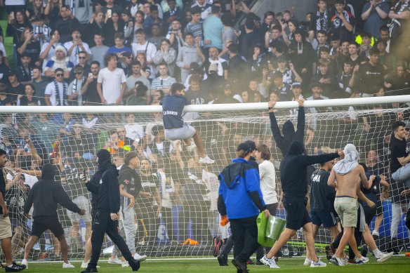 Melbourne Victory fans invade the AAMI Park pitch during the A-League game against Melbourne City on December 17.