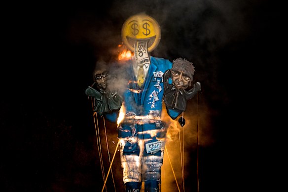 An 11-metre effigy of depicting a Ticketmaster figure holding British musicians Liam and Noel Gallagher from the band Oasis is set on fire on November 2, 2024 in Edenbridge, England. Each year the Edenbridge Bonfire Society creates a ‘Celebrity Guy’ effigy of an infamous public figure which is burnt during the annual bonfire night celebrations.