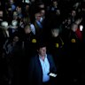 Spectators roam inside the Madrid Open tennis tournament venue during a general blackout.