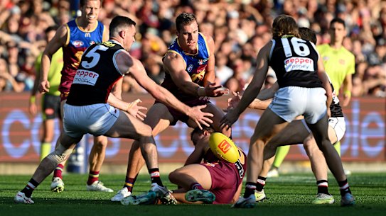Jack Payne of the Lions and Brad Crouch of the Saints compete for the ball.