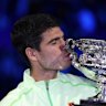 Carlos Alcaraz celebrates with his trophy.