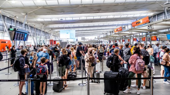 Travellers queue at Sydney’s domestic airport on Tuesday.
