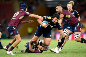Thomas Umaga-Jensen of the Highlanders is tackled during the round 12 match against the Reds.