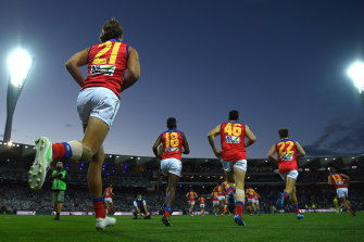 Lions players take to the field in Geelong.
