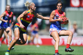Libby Birch of the Demons and Erin Phillips compete for the ball.