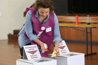 An official sanitises voting areas during the local government election in Brisbane in March.