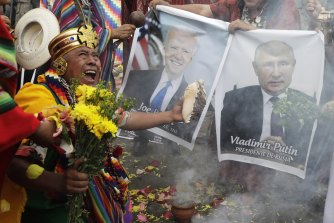 Shamans in Lima, Peru, hold photos of US President Joe Biden and Russia’s Vladimir Putin during a year-end ritual where thy asked world leaders be cleansed, so they can make wise decisions in the coming year.