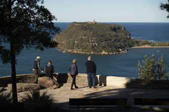 Soaring views: Visitors at West Head, in the Ku-Ring-Gai Chase National Park, look eastwards towards the Barrenjoey Lighthouse on Wednesday.