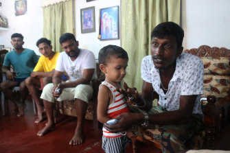 Fisherman Pathmanathan Anthony Pradeep with his son and other members of the group who travelled from Sri Lanka to Australia by boat on their friend’s trawler.