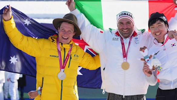 Silver medallist Ben Tudhope, of Australia, gold medallist Emanuel Perathoner of Italy and bronze medallist Lee Jehyuk of South Korea, pose with their medals after the men’s snowboard cross SB-LL2.