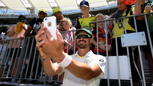 Smile: Mitchell Starc takes a selfie with young fans after Tuesday's clinical finish in Perth.
