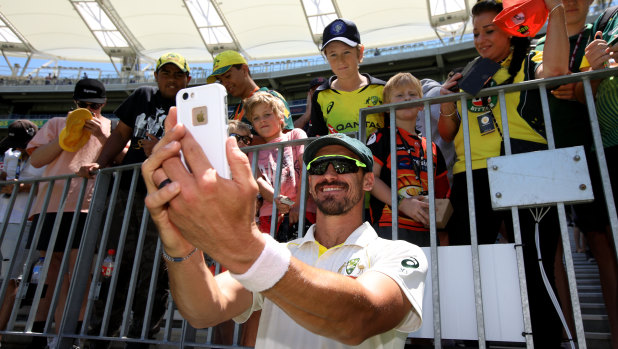 Smile: Mitchell Starc takes a selfie with young fans after Tuesday's clinical finish in Perth.