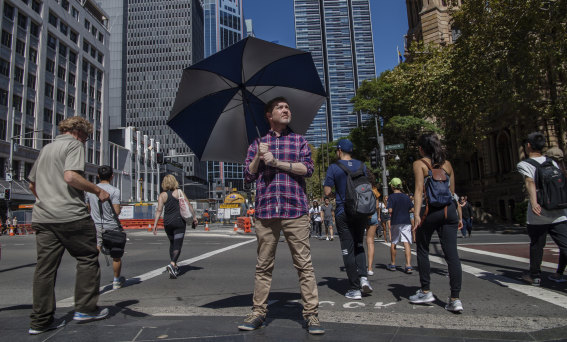 Damien MacRae wants to see more Australians protect themselves from the sun using an umbrella.