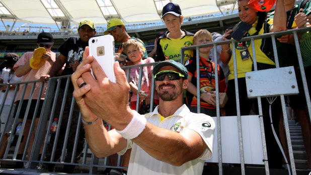 Smile: Mitchell Starc takes a selfie with young fans after the clinical finish in Perth.