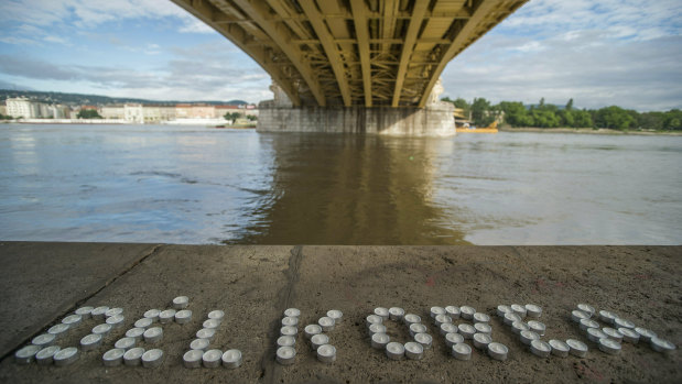 Candles make up the name of South Korea under the Margaret Bridge where a boat carrying South Korean tourists sank in Budapest, Hungary.