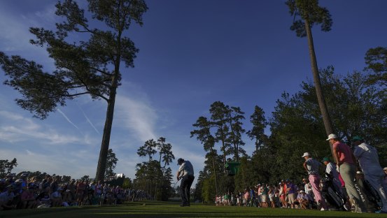 The beauty: Phil Mickelson drives at the 18th at Augusta National.