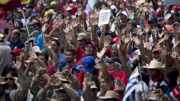 Supporters of Venezuelan President Nicolas Maduro raise their hands swearing allegiance to the fatherland during an "anti-intervention" march this week.