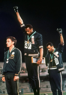 US athletes Tommie Smith and John Carlos, with Australia's Peter Norman, in their famous pose at the 1968 Games in Mexico. 