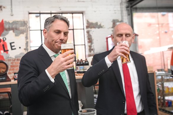 Deputy Prime Minister Richard Marles (left) and UK Secretary of State for Defence John Healey enjoy a beer in Geelong after signing the Geelong Treaty for co-operation on SSN-AUKUS last July.