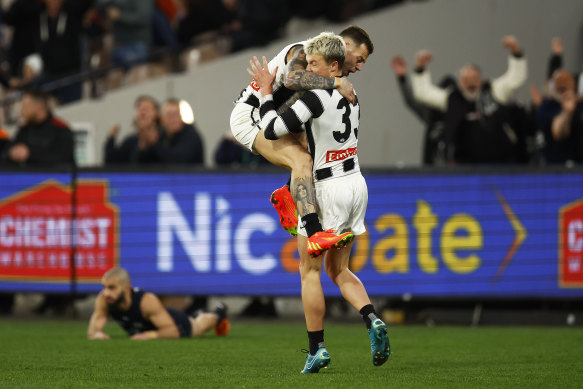 Jamie Elliott celebrates with Jack Ginnivan after scoring.