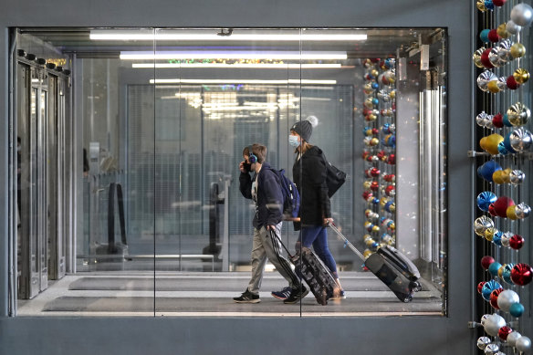 Travellers walk through O'Hare International Airport in Chicago, where authorities are bracing for a spike in COVID cases due to the Thanksgiving weekend travel. 