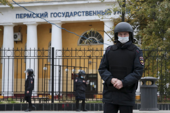 Police officers guard an area in front of the Perm State University in Perm.