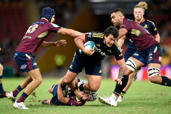 Thomas Umaga-Jensen of the Highlanders is tackled during the round 12 match against the Reds.