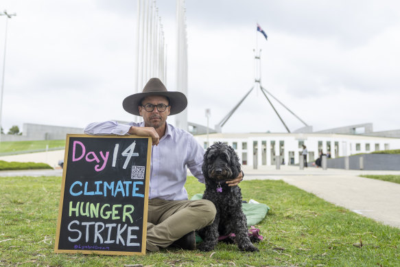Gregory Andrews with his dog Fred on the lawns on Parliament House in Canberra. 