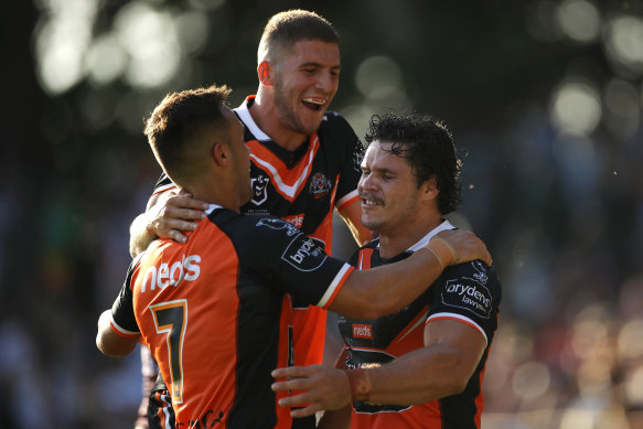 Luke Brooks, Adam Doueihi and James Roberts celebrate a Wests Tigers try last year.