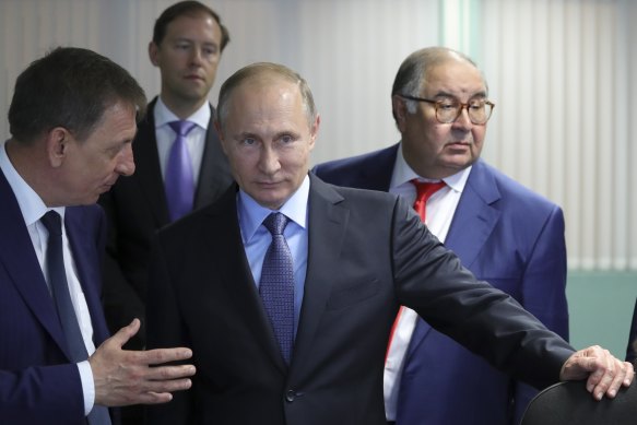 Russian President Vladimir Putin with Alisher Usmanov to his right in 2017.