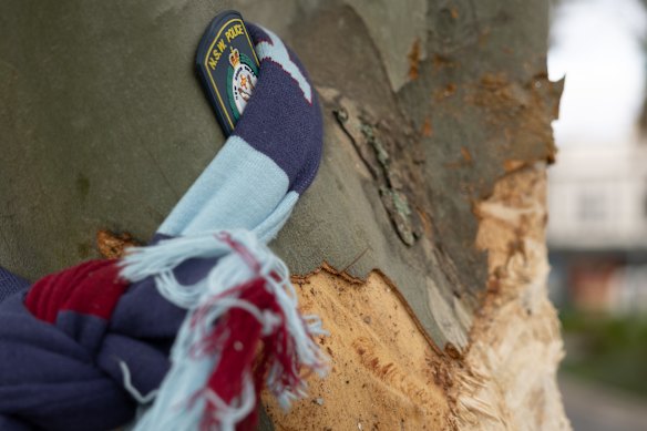 A NSW Police badge is tied to the tree at Gibbons Street.