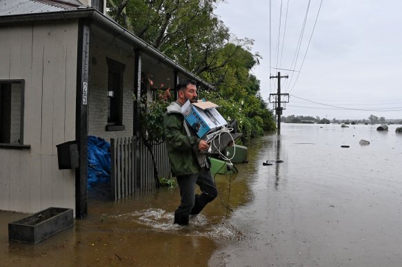 Ben Sullivan retrieves a few last items before he evacuates his inundated home in Windsor. 