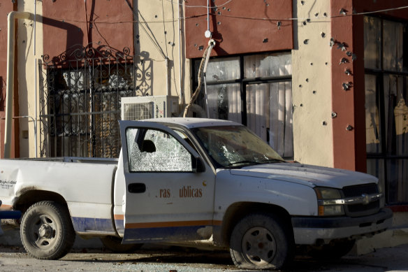 A damaged vehicle is parked at the City Hall of Villa Union, Mexico, on Saturday.